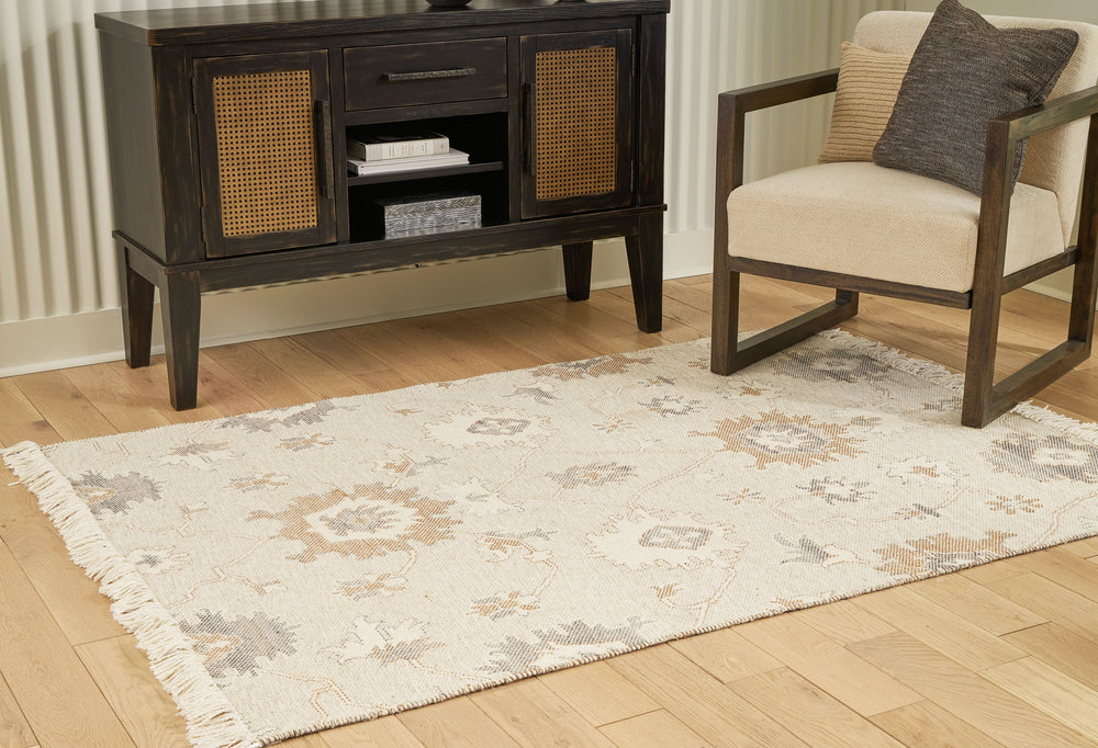 Bring modern life into balance with the rhythms and beauty of nature. This area rug has the vintage look of an heirloom. Blooming with graceful florals in neutral tones and surrounded by fringe edging, it adds style to any lounge space.<br/><br/><b>Produc