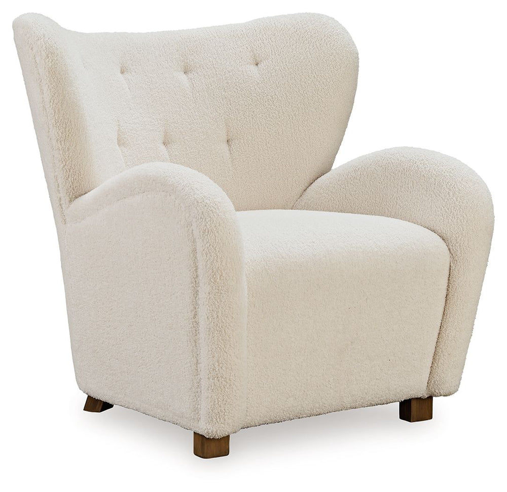 High style meets relaxation in this accent chair. Cozy faux shearling fabric keeps the look contemporary without compromising on comfort. A tufted wingback design and dramatic slope arms add high-fashion flair. It-'s the perfect place to curl up and enjoy