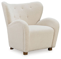 High style meets relaxation in this accent chair. Cozy faux shearling fabric keeps the look contemporary without compromising on comfort. A tufted wingback design and dramatic slope arms add high-fashion flair. It-'s the perfect place to curl up and enjoy