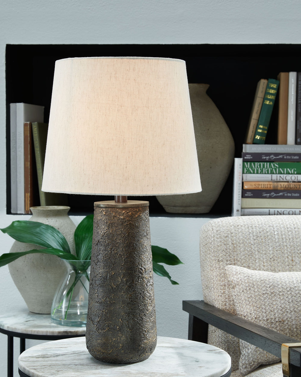 Modern industrial design in a new light. A mixed-media masterpiece, this table lamp provides maximum interest and exceptional versatility with its heavily textured surface. Whether resting on your nightstand or set on a side table, it delivers a unique ae