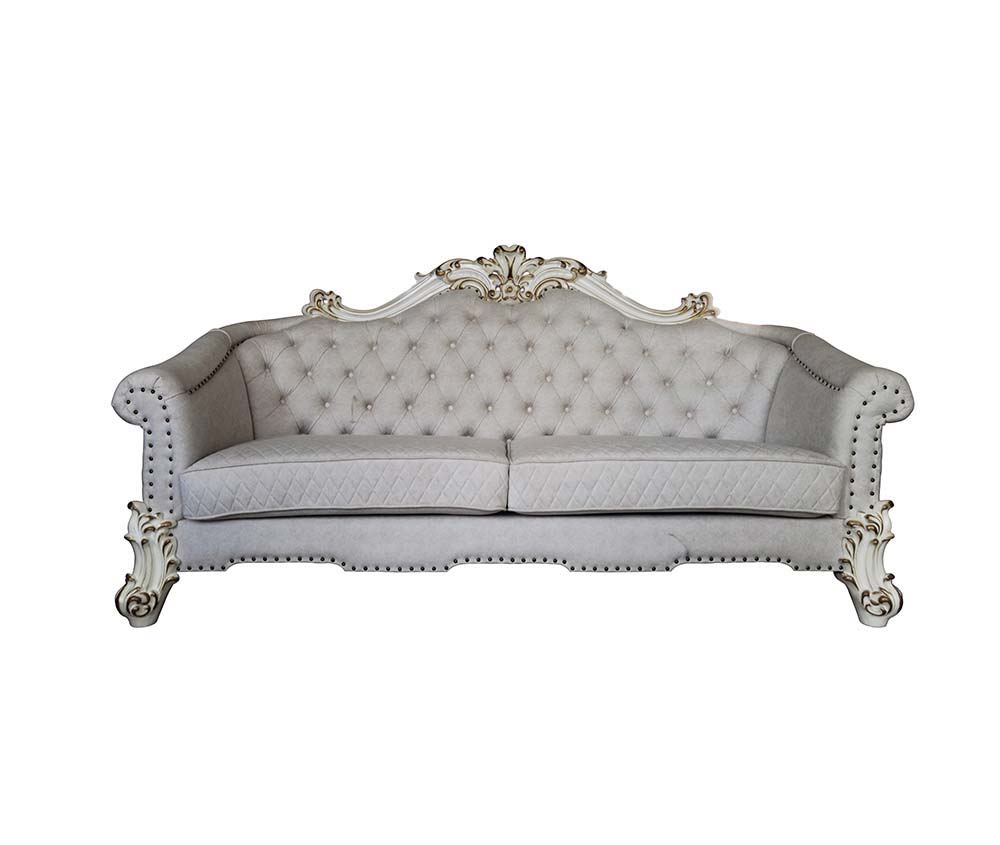 Tracing back to the classical Baroque era, expressed with intent and conviction, our new interpretation of Vendome II is donned. The Vendome II sofa-'s light gray fabric is grand and classy with crystal like button tufting on the back in a crackled gold p