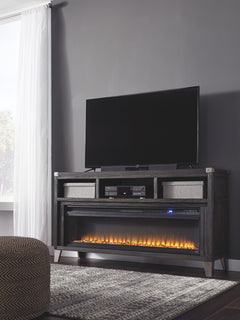 Make watching TV a joy with this large TV stand. Top surface accommodates up to 70-inch TVs. Its rustic-industrial style is sure to complement any contemporary decor through gray coloration, squared edges, zinc-tone corner bracket accents and nailhead det