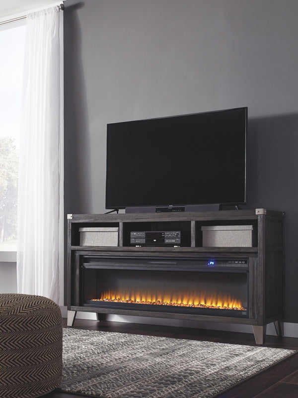 Make watching TV a joy with this large TV stand. Top surface accommodates up to 70-inch TVs. Its rustic-industrial style is sure to complement any contemporary decor through gray coloration, squared edges, zinc-tone corner bracket accents and nailhead det