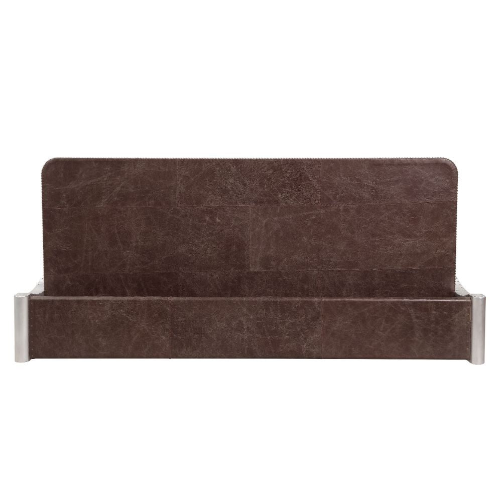 The Brancaster Aluminum Desk-'s modern look and industrial styling include retro brown top grain leather top, aluminum over plywood construction, and exposed rivets that form a patchwork over the frame. A brilliant addition to your workspace, this desk fe