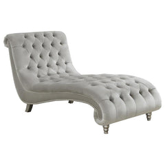 Grace your living area or master suite with this exceptional chaise lounge. Upholstered in luxurious grey velvet, this piece creates an eye-catching display. All-over button tufting is enhanced with metallic buttons. Nail head trim adorns the frame for st