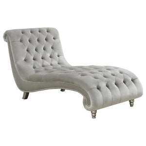 Grace your living area or master suite with this exceptional chaise lounge. Upholstered in luxurious grey velvet, this piece creates an eye-catching display. All-over button tufting is enhanced with metallic buttons. Nail head trim adorns the frame for st