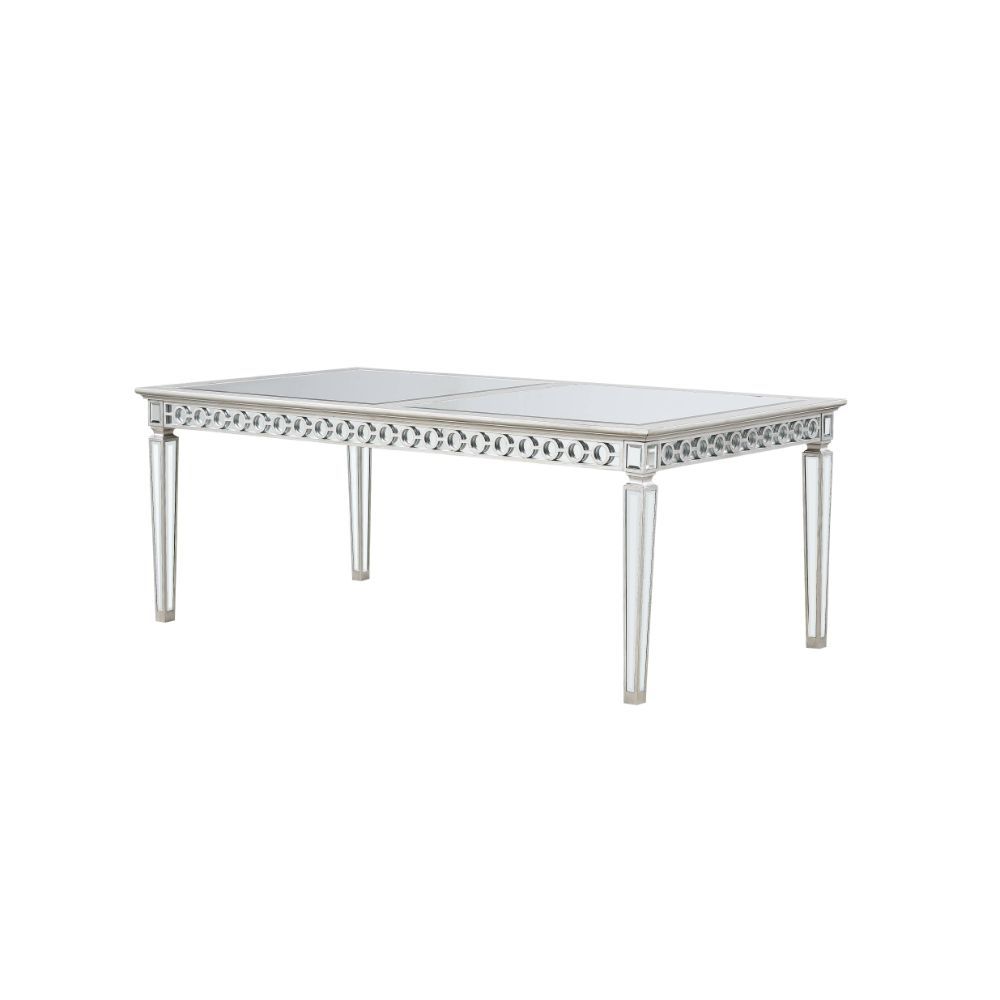 Let the Varian dining collection reflect your brilliant style! This chic set features a rectangular table accented with a beveled mirror trim in a geometric design. The matching chairs are upholstered in a lustrous blue fabric and supported by elegantly t