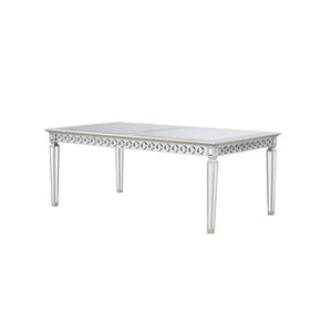 Let the Varian dining collection reflect your brilliant style! This chic set features a rectangular table accented with a beveled mirror trim in a geometric design. The matching chairs are upholstered in a lustrous blue fabric and supported by elegantly t