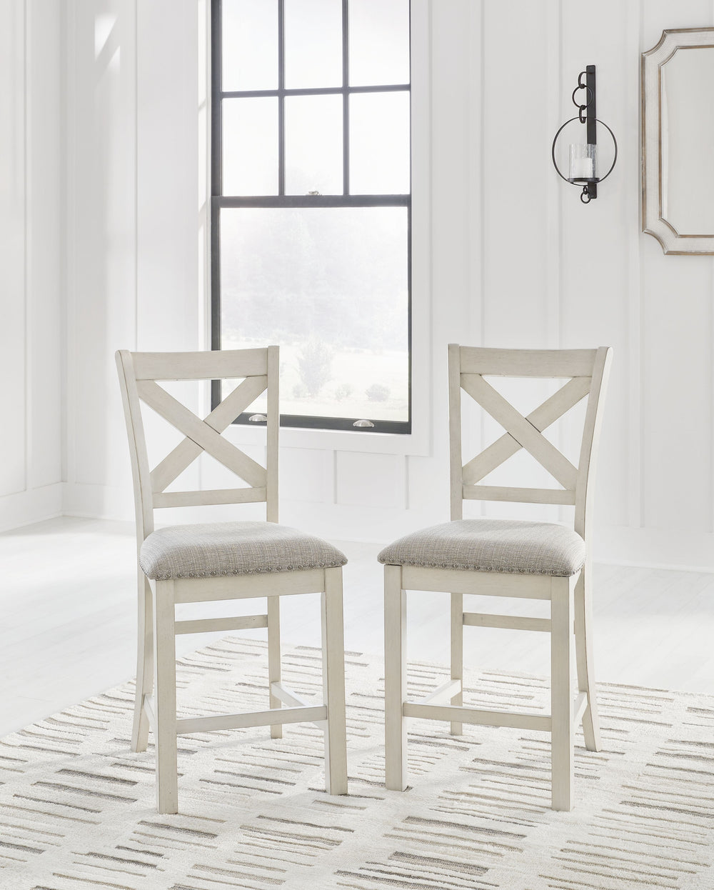 This counter height bar stool is sure to impress come mealtime. With its white finish and light gray upholstery, farmhouse-style seating has never been so fashionable. All thatâ€™s missing is you and your family.<br><br><b>Additional Dimensions</b><br><ul
