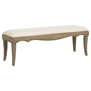 This French Provincial-inspired bed-end bench combines timeless elegance with functional comfort. Framed in solid poplar, engineered wood, and mango veneer, it features a washed mango finish that highlights the natural wood grain. The cushioned seat is up