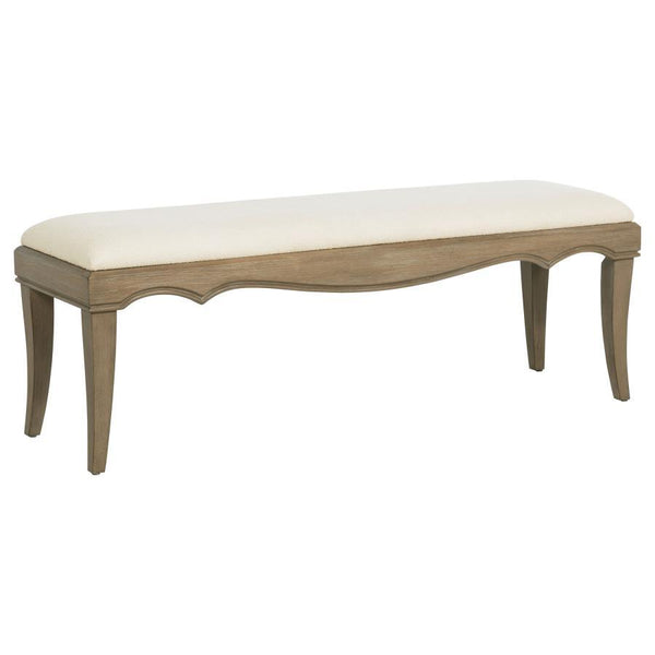 This French Provincial-inspired bed-end bench combines timeless elegance with functional comfort. Framed in solid poplar, engineered wood, and mango veneer, it features a washed mango finish that highlights the natural wood grain. The cushioned seat is up
