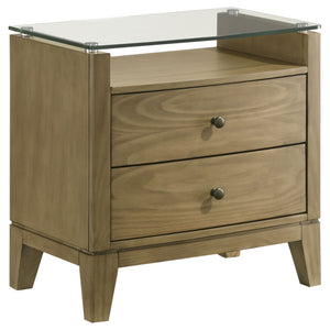 This nightstand is a perfect blend of style and functionality, featuring a natural pine finish that exudes a warm and inviting aura. Its top drawer offers cord management access, ideal for recharging devices conveniently. The piece-'s softly curved fronts