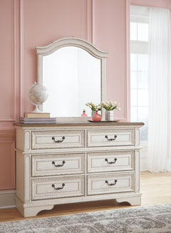 Elevating the art of traditional cottage styling, this dresser and mirror set is your dream bedroom retreat realized. This brilliantly crafted bedroom ensemble wows with dramatic scalloped details and an antiqued two-tone aesthetic, blending a chipped whi