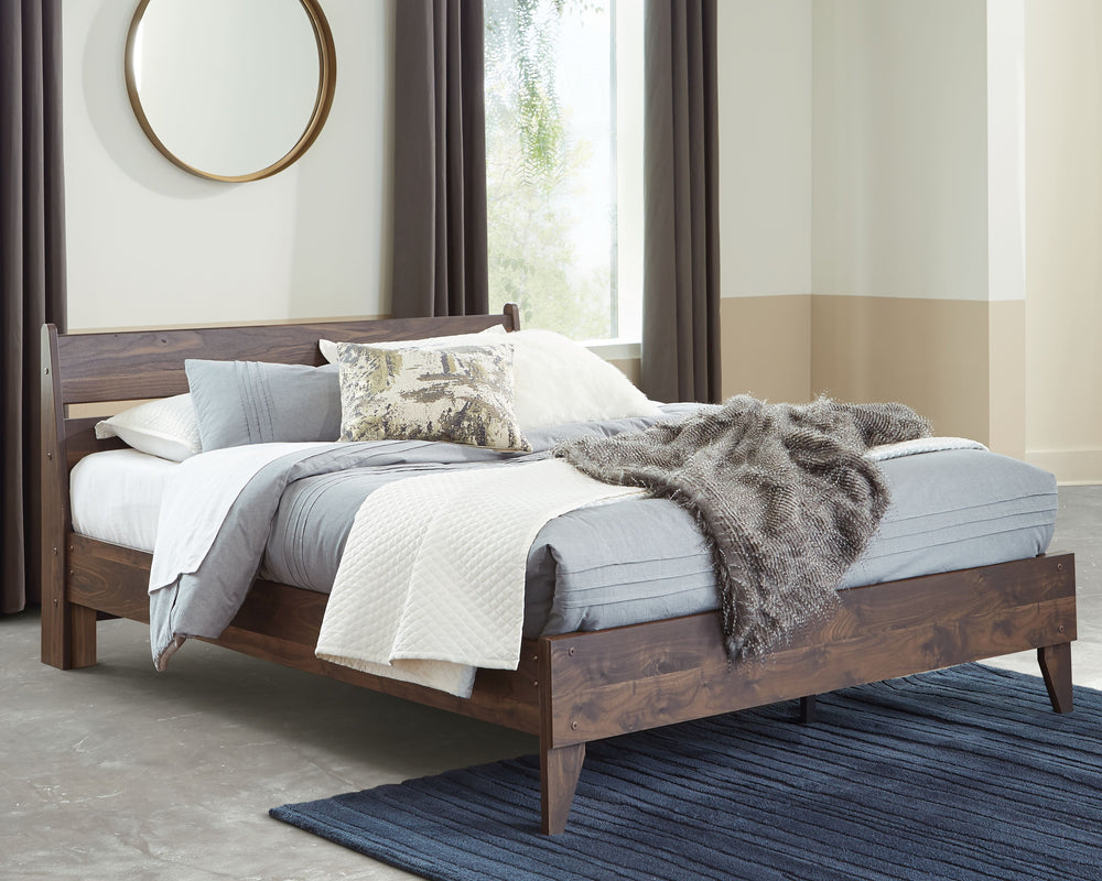 At the intersection of classic cool and chic sophistication youâ€™ll find this queen panel platform bed. The rich brown finish over replicated walnut wood grain offers an authentic touch that plays well any way you style it. Minimal yet elegant in its des
