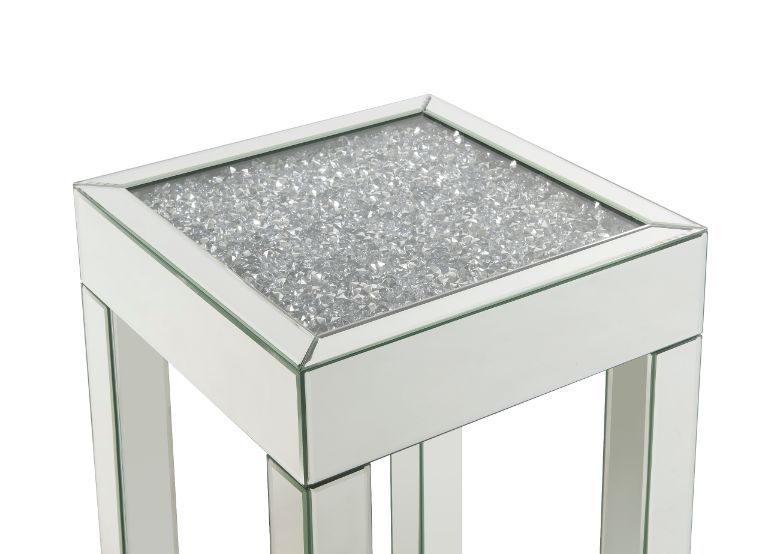 This piece strikes a sleek, clean-lined silhouette accented by faux diamonds and mirrored finish. Adding depth and dimension to your room while upping the wow factor in your home. This Noralie End Table is ideal for displaying your precious family photos 