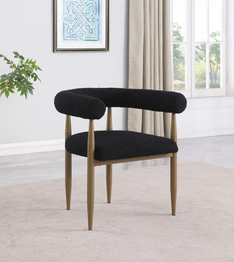 Update your dining table with the fresh ambiance and vintage inspired character of a set of two modern armchairs. Each features a compelling silhouette with a U-shaped backrest and arms. Black boucle upholstery adds the perfect dose of texture and depth, 