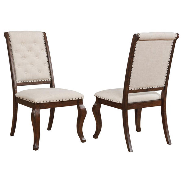 Antique java finish is a beautiful choice for this exceptional transitional dining side chair from the Brockway collection. Beautiful in any dining room, the chair offers a semi-formal, indulgent look with an upholstered, tufted back. Traced in nailhead t
