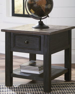  this rectangular end table is all the talk of todayâ€™s design world. Wood grain shows through the weathered gray-brown top in all of its earthy pleasure. Lovely traditional hardware adorns the framed drawer.<
