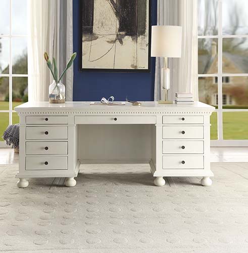 The Gustave Executive Desk is an elegant and versatile piece that can be used both at home and at work. This executive desk features a top and base with molding trim and pre-cut holes with covers for electrical cord management, while the finished back fea