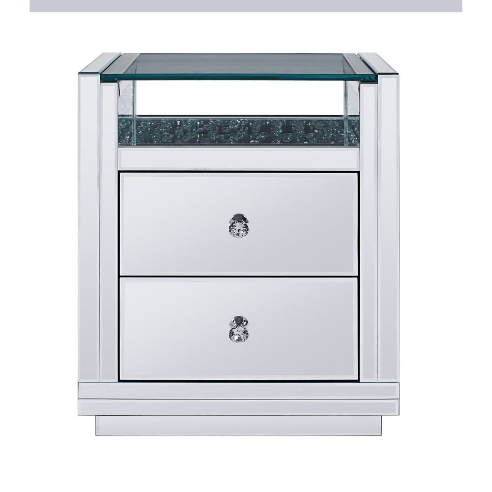 The Nysa End Table will give any room a touch of glamour. This contemporary nightstand is fully mirrored with a beveled edge and stunning glass top with a storage shelf surrounded by faux crystal inlay. Use this unique piece as the perfect accent for any 