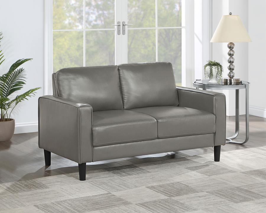 A compact profile makes this modern loveseat the perfect choice to add seating in a living room or den. Itâ€™s a structured silhouette complete with track arms. Faux leather upholstery is supple and smooth, offering contemporary style and sophistication t