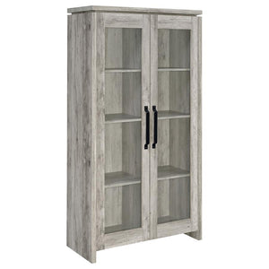 This tall curio cabinet makes for an impressive addition to a well-appointed home. The charming cabinet has classic sense of style and design. Two glass doors with contrasting dark hardware give the curio a distinguished appearance. The doors provide easy