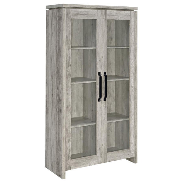 This tall curio cabinet makes for an impressive addition to a well-appointed home. The charming cabinet has classic sense of style and design. Two glass doors with contrasting dark hardware give the curio a distinguished appearance. The doors provide easy