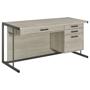 Elevate your contemporary home office and organize your supplies with this spacious contemporary office desk, featuring a light and bright whitewashed grey finish that maintains a clean look and feel to the space. Four drawers, including a deep file drawe
