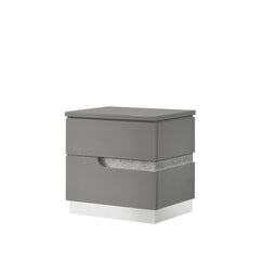 The Paradox Two Drawer Nightstand in Gray brings a blend of contemporary appeal and functional elegance to your bedroom. Featuring a gleaming Gray gloss laminate finish, this nightstand offers a sleek and modern look with the added benefits of scratch and