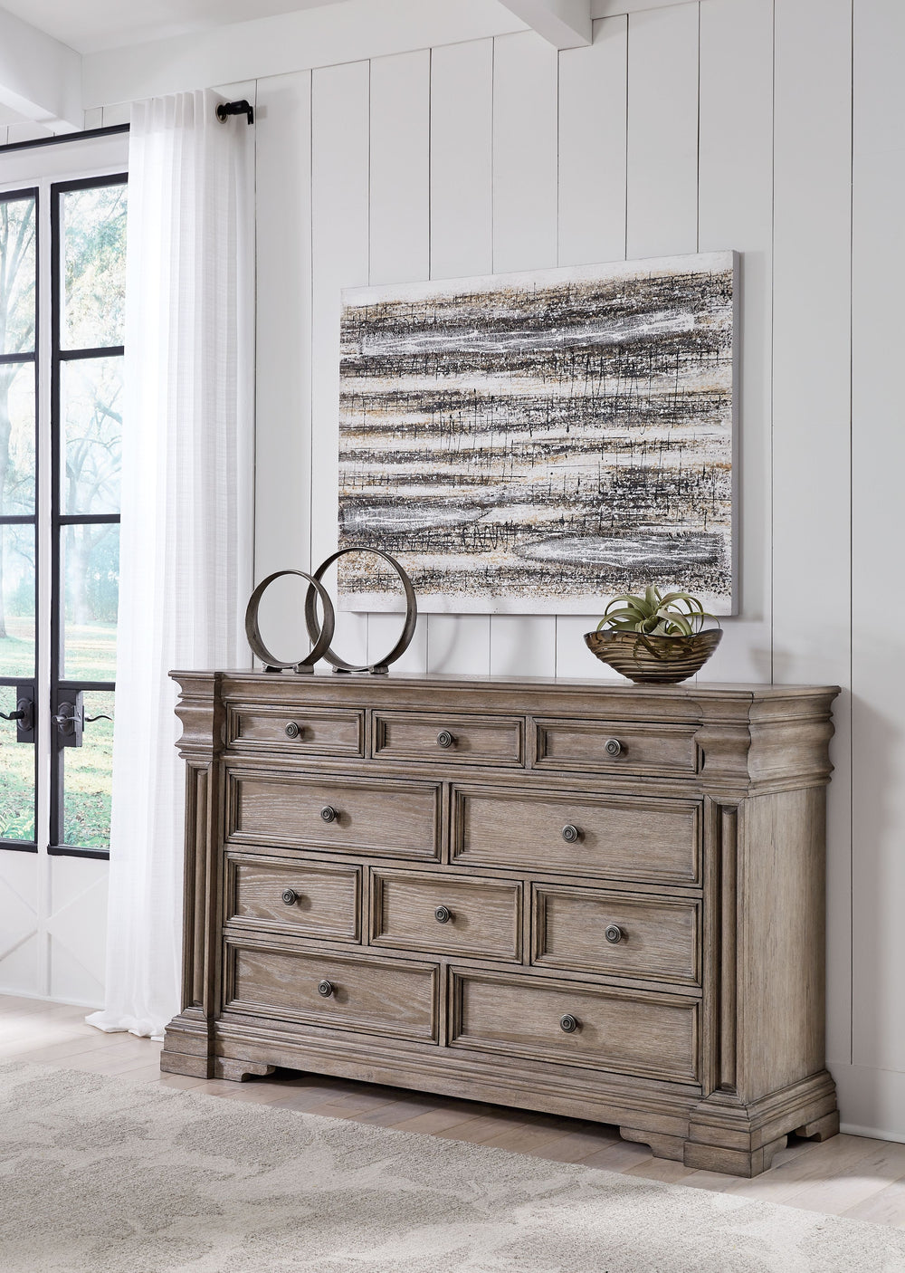 Discover something exceptional with this dresser. Its impressive silhouette offers a casual traditional aesthetic, embodied by classic-inspired columns and a relaxed grayish brown finish. Inset framed drawers of various sizes are casually cool and packed 