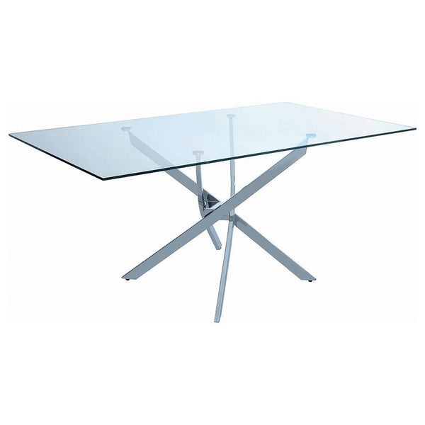 This rectangular dining table delivers sculptural impact with a crisp modern profile. Its clear tempered glass top offers a clean, durable surface that visually opens the space. Below, a striking asterisk-shaped base crafted from heavy gauge metal adds ar