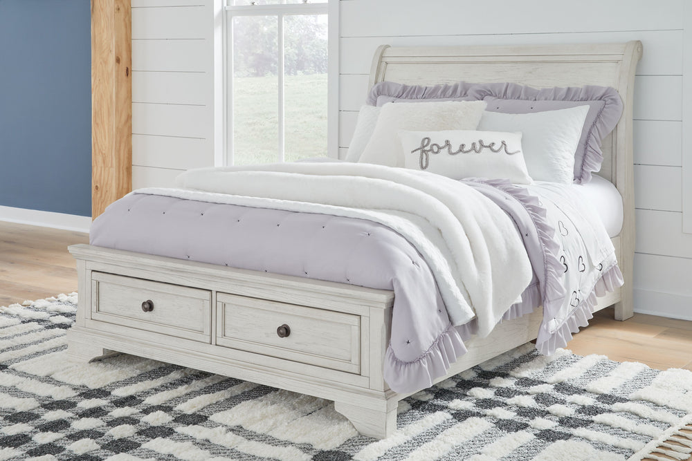 Elegant, timeless furnishings take your bedroom to the next level. Nothing does that better than this full sleigh bed with storage footboard. The antiqued white finish with a wonderful grain texture radiates sophistication, while drawers with dark bronze-