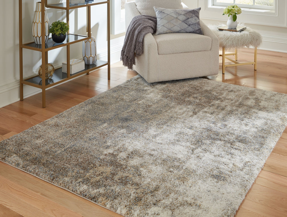 This area rug features a cloudy abstract pattern of ivory, beige, brown and shades of gray. Plush pile is loaded with fun, feel-good texture. Harmonious hues make it a tasteful choice for so many spaces.<br/><br/><b>Product Features</b><ul><li>Made of pol