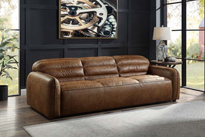 The allure of the Rafer sofa lies in details like piped seams, full foam seat cushions, and Cocoa top grain leather upholstery. These are balanced with an inviting profile, creating a piece that fits perfectly in a casual apartment as it does a formal liv