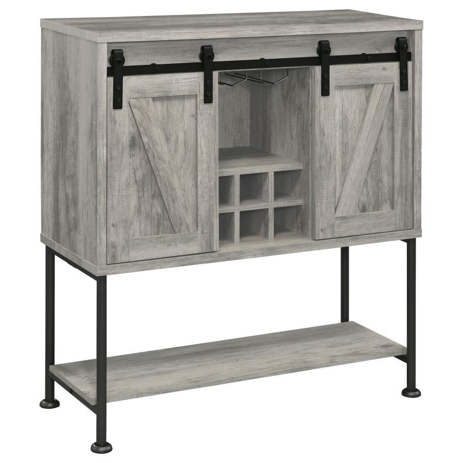 Perfect for a cottage or lakeside getaway, this bar cabinet features a light grey driftwood finish that is charming and cheerful. Place this bar cabinet in a rustic farmhouse home, as it offers country charm with two sliding barn doors that offer ample st