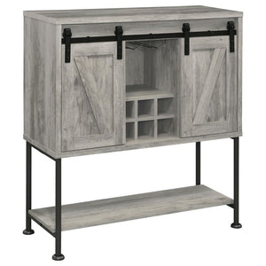 Perfect for a cottage or lakeside getaway, this bar cabinet features a light grey driftwood finish that is charming and cheerful. Place this bar cabinet in a rustic farmhouse home, as it offers country charm with two sliding barn doors that offer ample st
