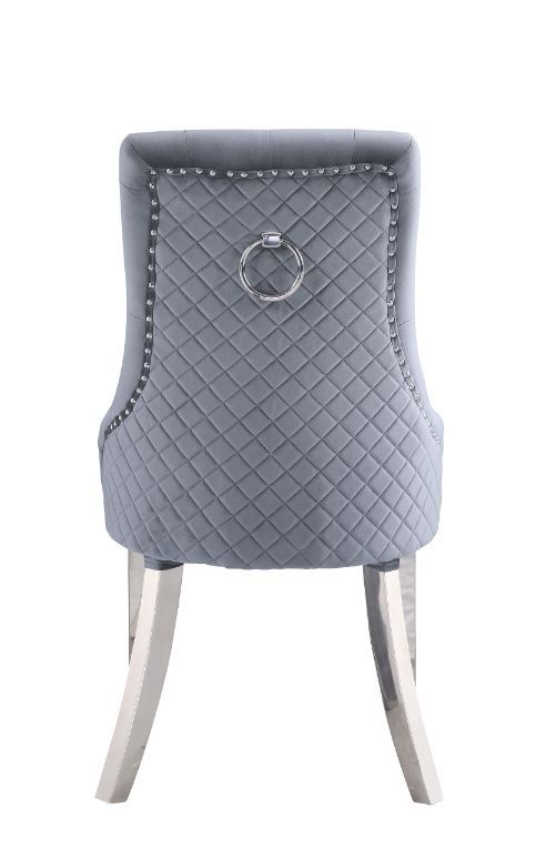 Contemporary flair graces classic silhouettes to create a timeless design that will blend with any home style. This Parson style side chair has an upholstered height back adorned by a sparkling nail-head border and a silver pull-ring, with button-tufted d