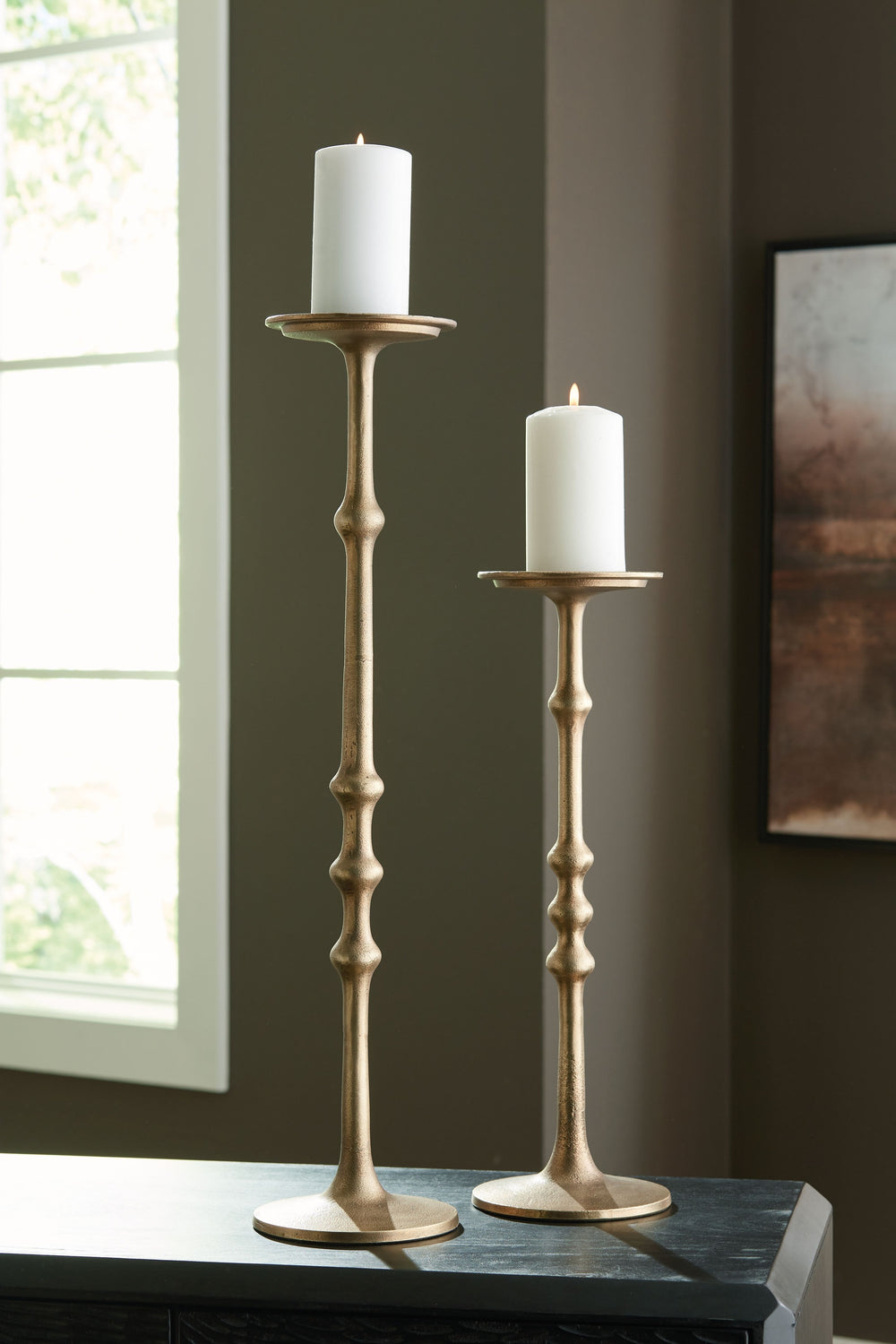 Inspired by ancient counting methods, this candle holder set features a unique notched design. The pieces, in two different sizes, add depth and create a festive atmosphere. Perfect for displaying pillar candles on a mantle or table, these metal candle ho