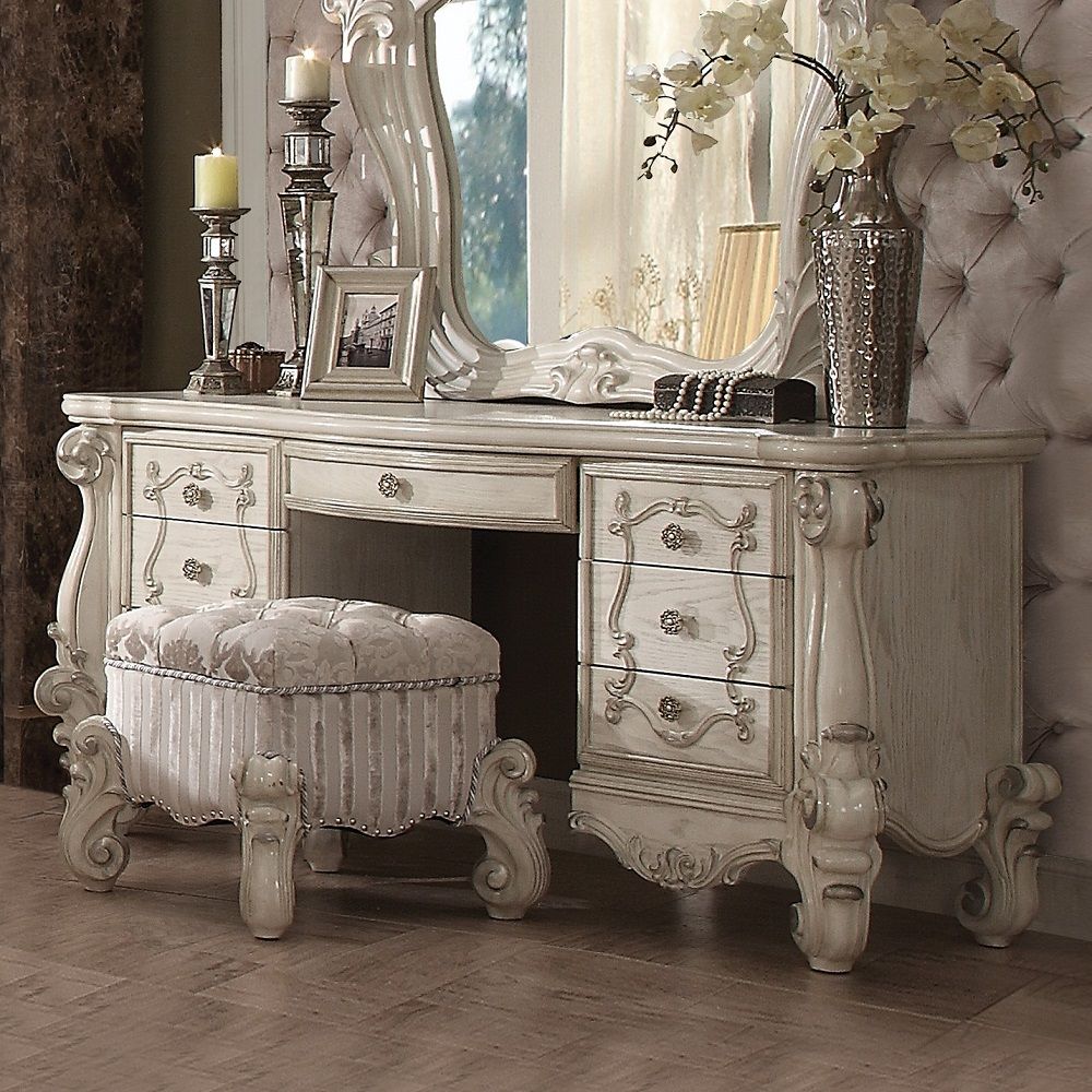 The Versailles vanity desk is the perfect accent to create the style of royalty your bedroom has been needing. This vanity desk crafted in wood with bone white finish was inspired by old European design with brown copper metal hardware and intricate wood 