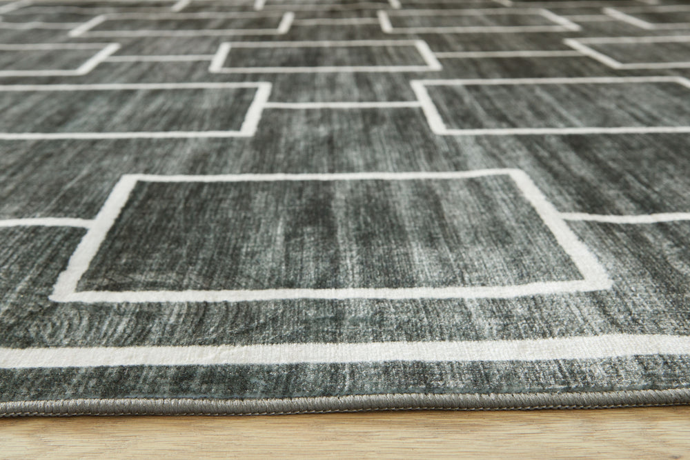 The soft, welcoming faux fur construction of this rug is complemented by a clean-lined geometric design. Its neutral black and gray tones give you the must-have versatility to pair with existing contemporary decor. Plus it-'s machine washable for added co