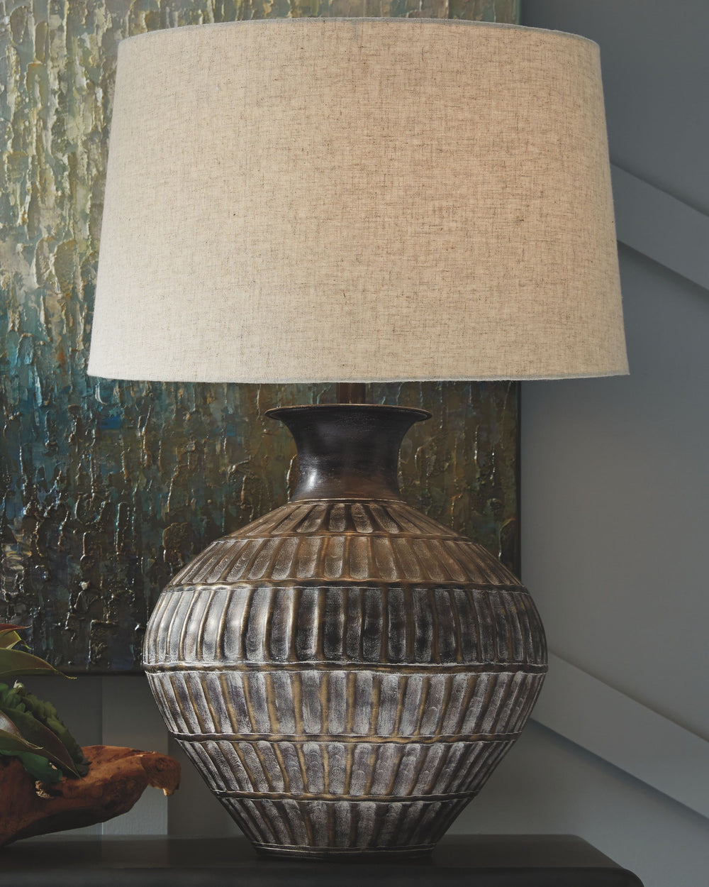 With this table lamp, you can cast a well-lit glow any time of day in style. Teeming with textured metal in a wide, shapely base, the bronze-tone finish gives that pop of casual chic flair youâ€™ve been looking for.<br><br><b>Additional Dimensions</b><br>