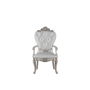 Exclusively designed and filled with romantic spirit, this beautiful chair features Queen Anne legs and carved apron and trim, decorated with raised and scrolled floral motifs in an antique champagne finish. This unique chair is upholstered in a cream fab