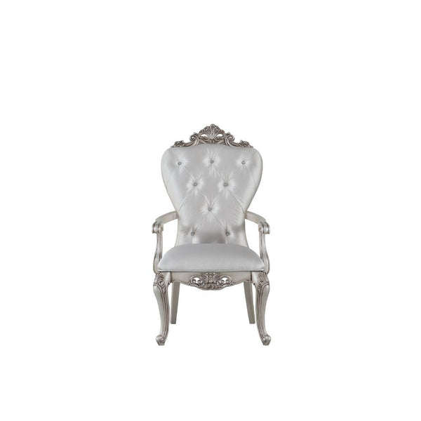 Exclusively designed and filled with romantic spirit, this beautiful chair features Queen Anne legs and carved apron and trim, decorated with raised and scrolled floral motifs in an antique champagne finish. This unique chair is upholstered in a cream fab