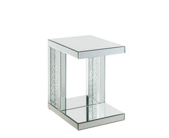 Go full glam with this Nysa Accent Table. The clear mirrored table top and glistening faux crystals inlay will reflect light and make any room appear larger. It provides a spacious table top ample enough for displaying various decor items while the unique