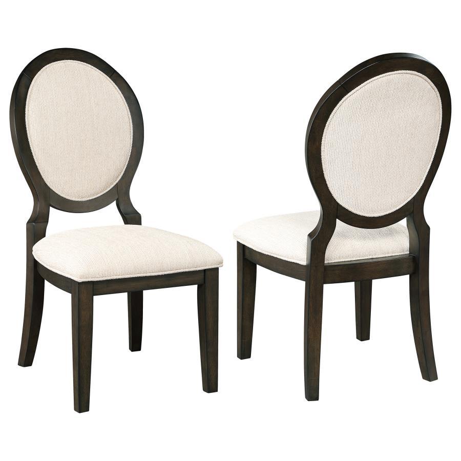 Elegant curves and contrasted finishes collide in this transitional side chair. A lovely addition to a dining space, this stunning chair can be slid up to a table for a comfortable place to sit over a long dinner, inviting you to lean back against its pad