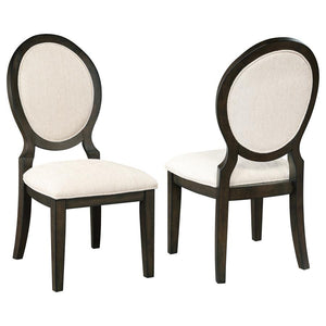 Elegant curves and contrasted finishes collide in this transitional side chair. A lovely addition to a dining space, this stunning chair can be slid up to a table for a comfortable place to sit over a long dinner, inviting you to lean back against its pad