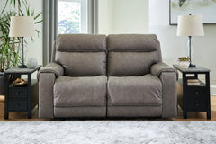 Destination: chic comfort. This power reclining loveseat launches your living room into superior form with stellar attention to detail. Exemplifying attainable luxury, its handsome hue has an air of sophistication youâ€™ll long to lounge in. And when youâ