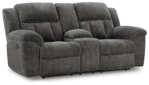 With its large-scale design, this extra-spacious reclining loveseat with console is a masterclass in accessible style. Plush, ultra-soft upholstery keeps everyone cozy as you lounge with family or guests. In a neutral hue, it seamlessly suits different ae