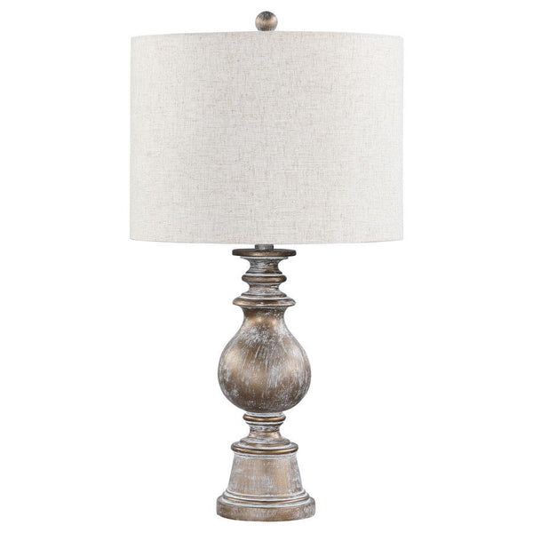 Dress up end tables and consoles with this elegant, contemporary table lamp. Designed with a contoured poly frame with intricate details, this sophisticated table lamp lends itself to transitional interiors easily. Enhanced by the weathered appearance of 
