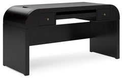 Inspired by art deco design, this softly shaped home office desk makes a lasting impression in a simply stunning way. Its magnificent curved silhouette is enhanced by a rich layered black finish on the textured wood grain surface. Complete with ample stor